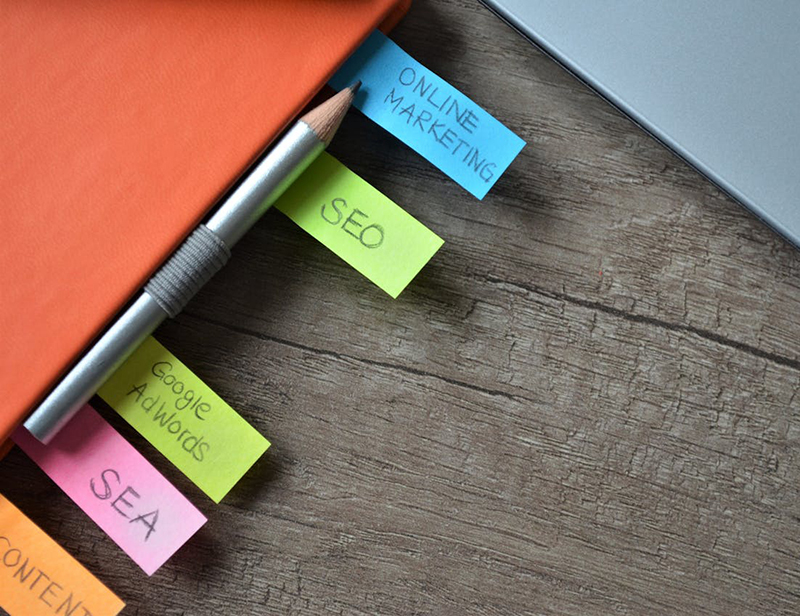 closeup of a notebook with different tabs including a tab for SEO notes